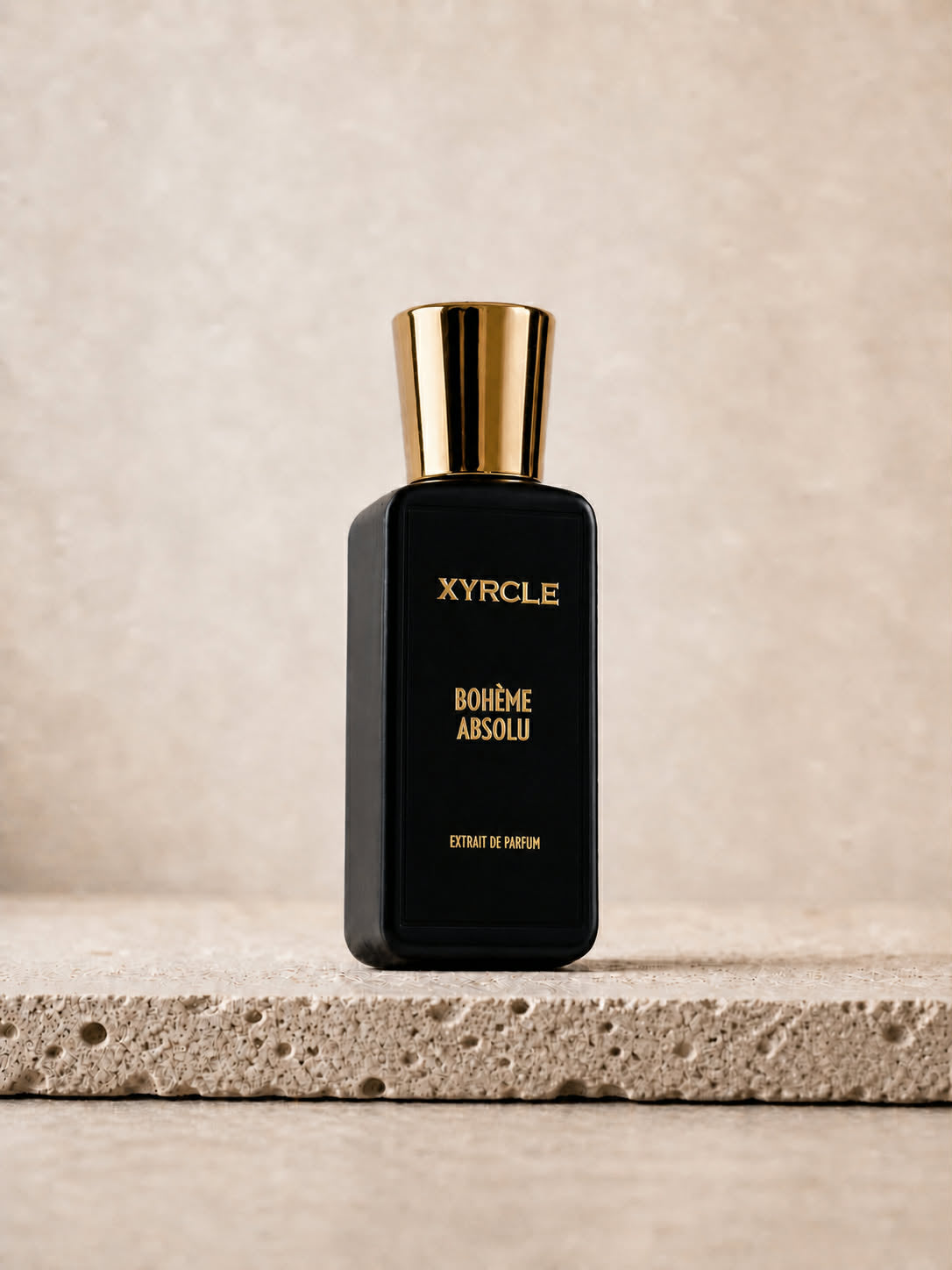 Sleek black perfume bottle labeled "XYRCLE BOHÈME ABSOLU" with a gold cap
